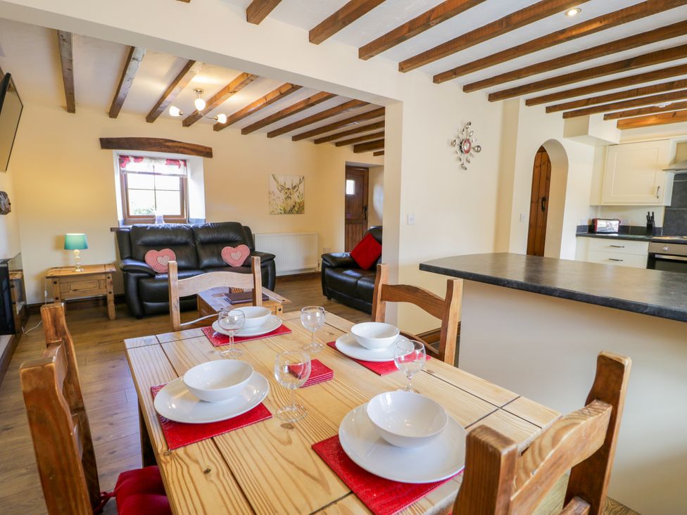 A dining area with table and chairs at Bwthyn Y Wennol Dolwen near Abergele
