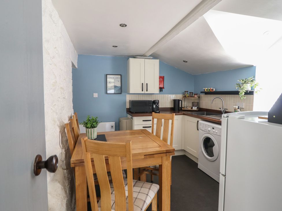 A kitchen with table and chairs at Arthur’s Cottage in Abergynolwyn near Tywyn