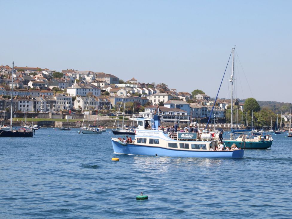 A boat on the river with buildings in the background at Dragonflies & Seahorses in Falmouth