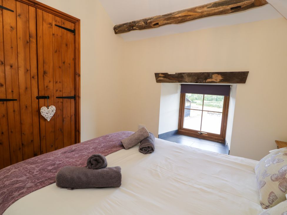 A bedroom with a bed and towels on it at Cornel Clyd in Dolwen near Abergele