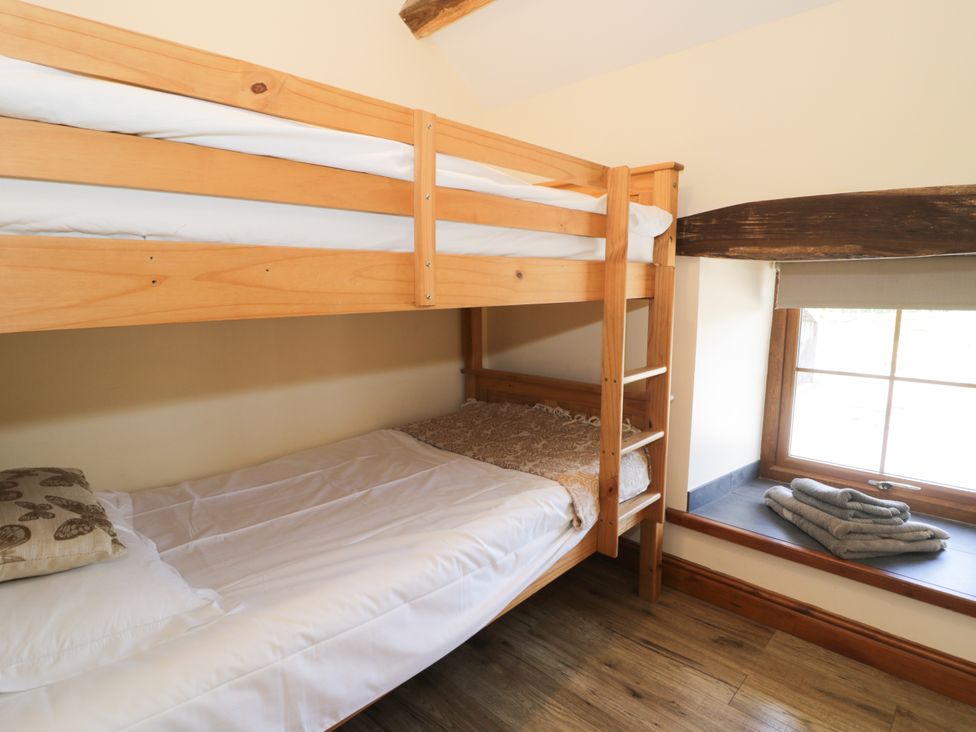 A bedroom with bunk bed and single bed at Cornel Clyd in Dolwen near Abergele