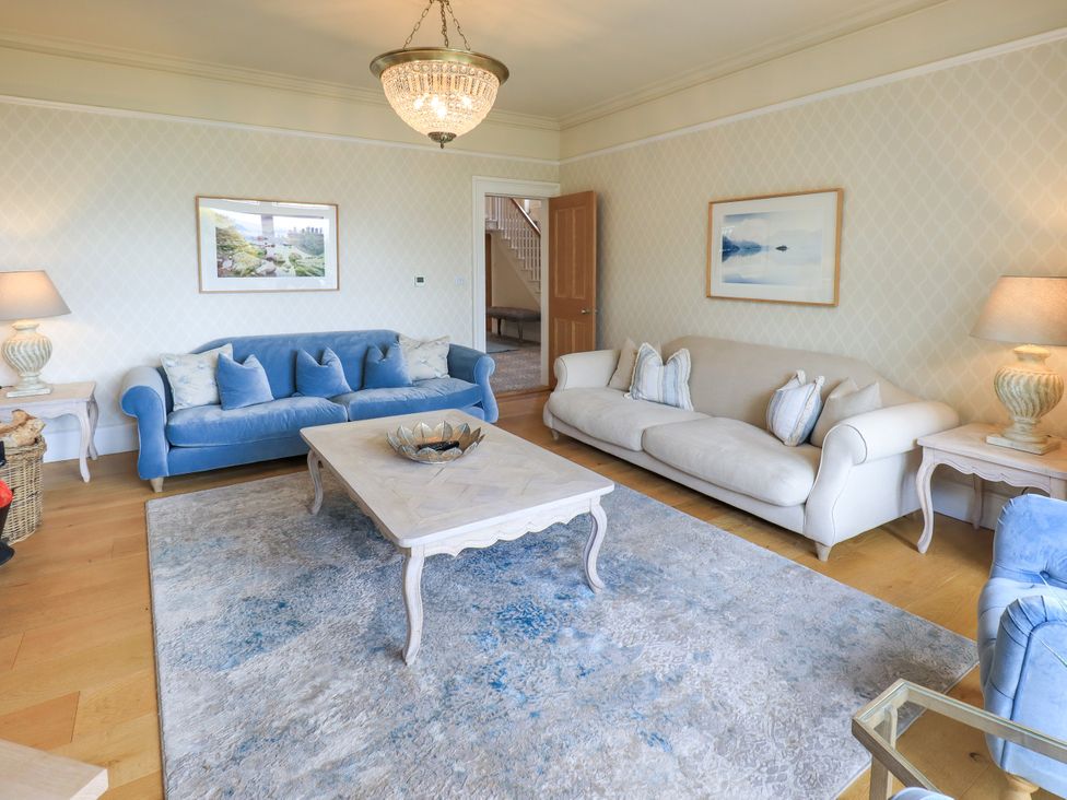 A living room with blue and white sofas and a coffee table at Fern Bank in Penrith