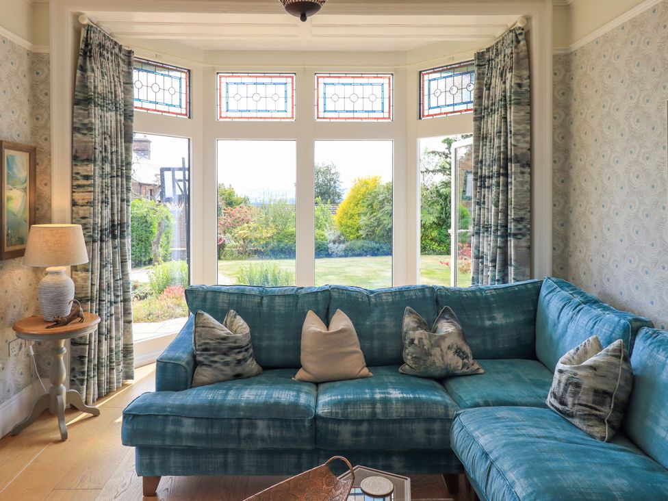 A living room with a sofa and lamp at Fern Bank in Penrith