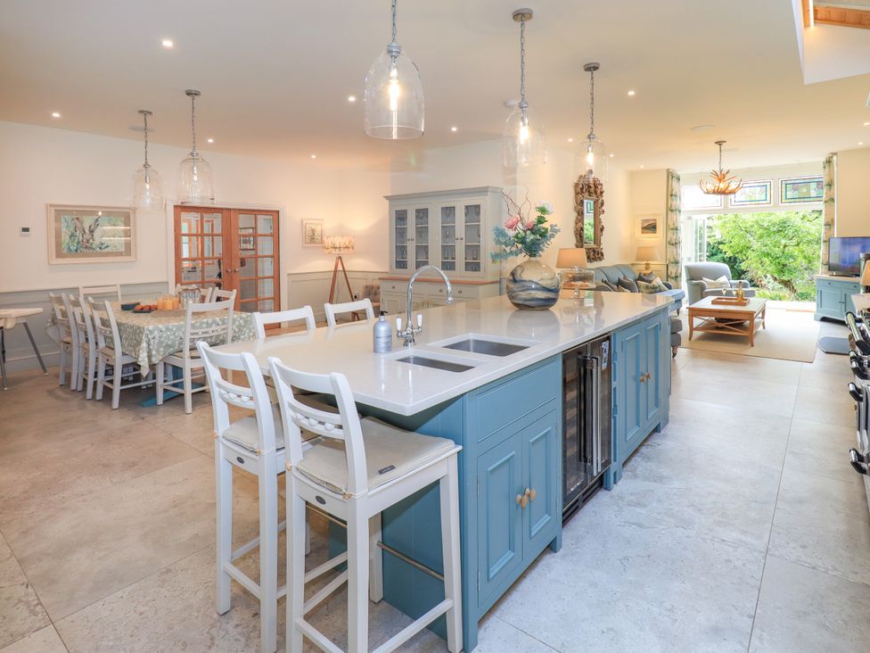 A kitchen with an island and dining area at Fern Bank in Penrith