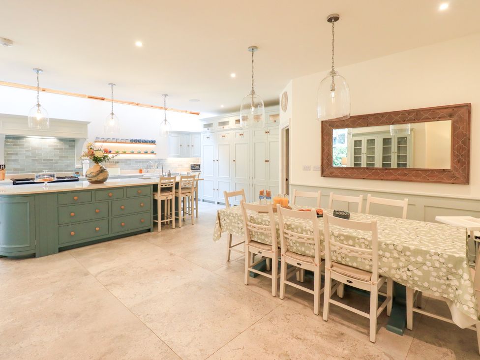 A kitchen with an island and dining area at Fern Bank in Penrith