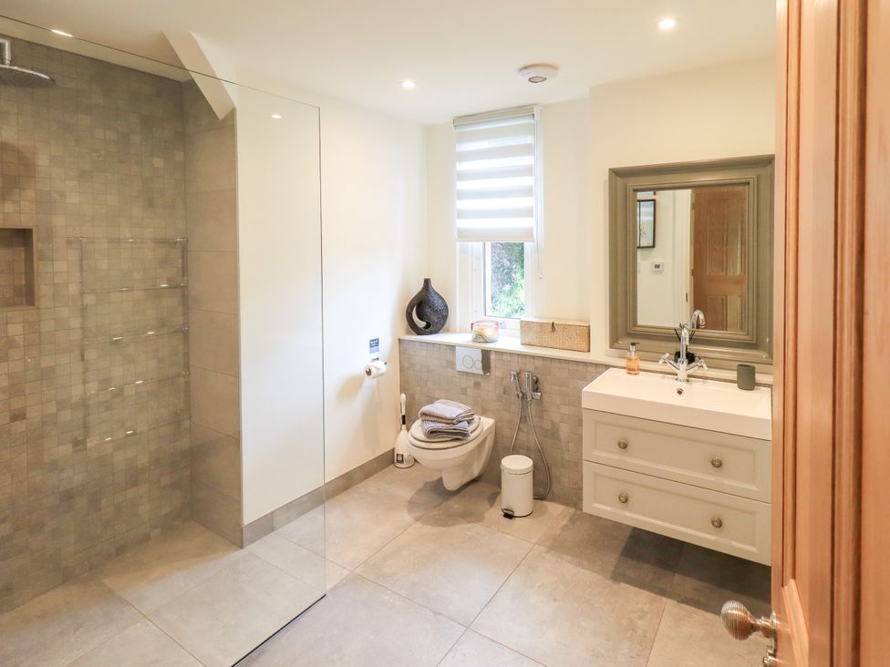 A bathroom with a shower, toilet, and sink at Fern Bank in Penrith