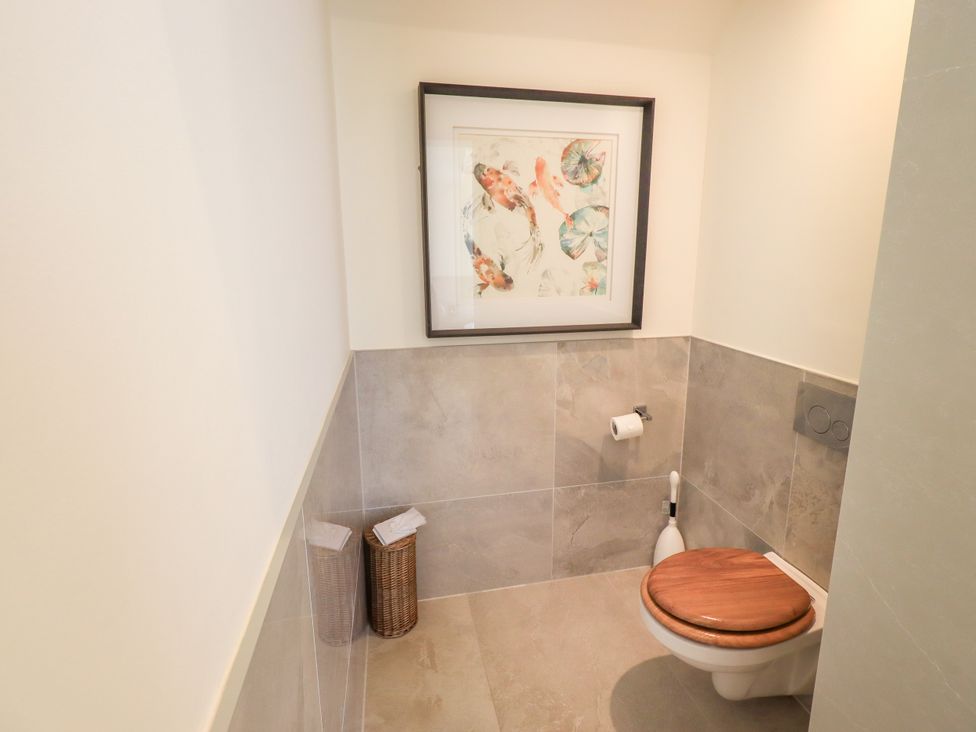 A bathroom with a toilet and artwork at Fern Bank in Penrith