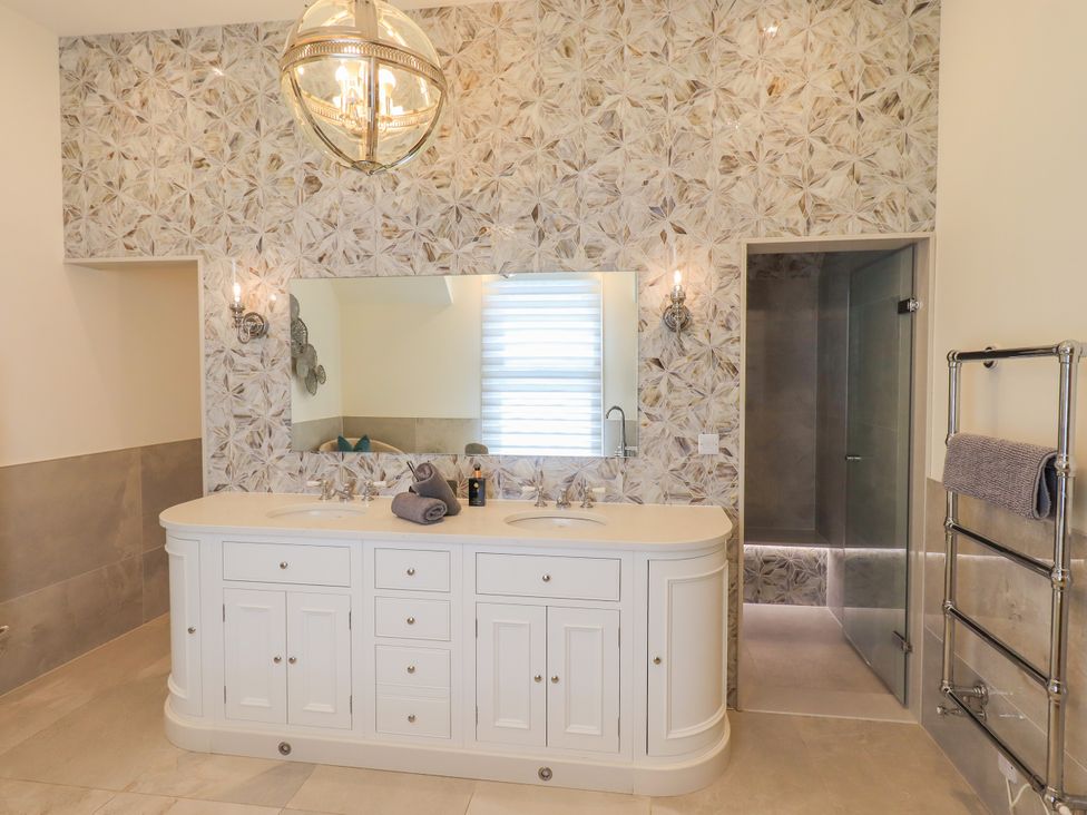 A bathroom with a vanity and mirror at Fern Bank in Penrith