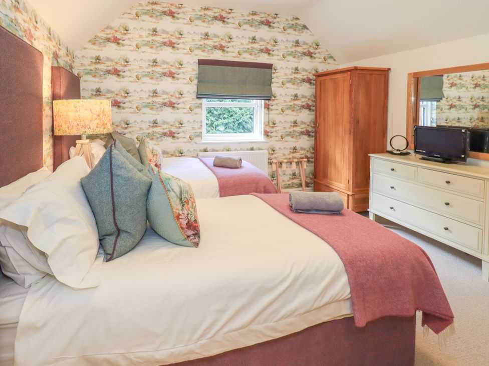 A bedroom with two beds and a dresser at Fern Bank in Penrith