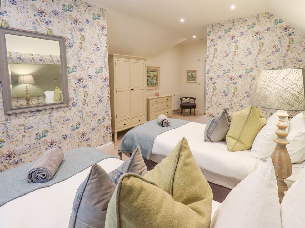 A bedroom with two beds and a dresser at Fern Bank in Penrith
