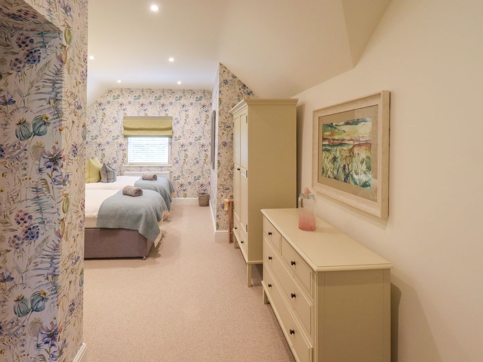 A bedroom with two beds and a dresser at Fern Bank in Penrith