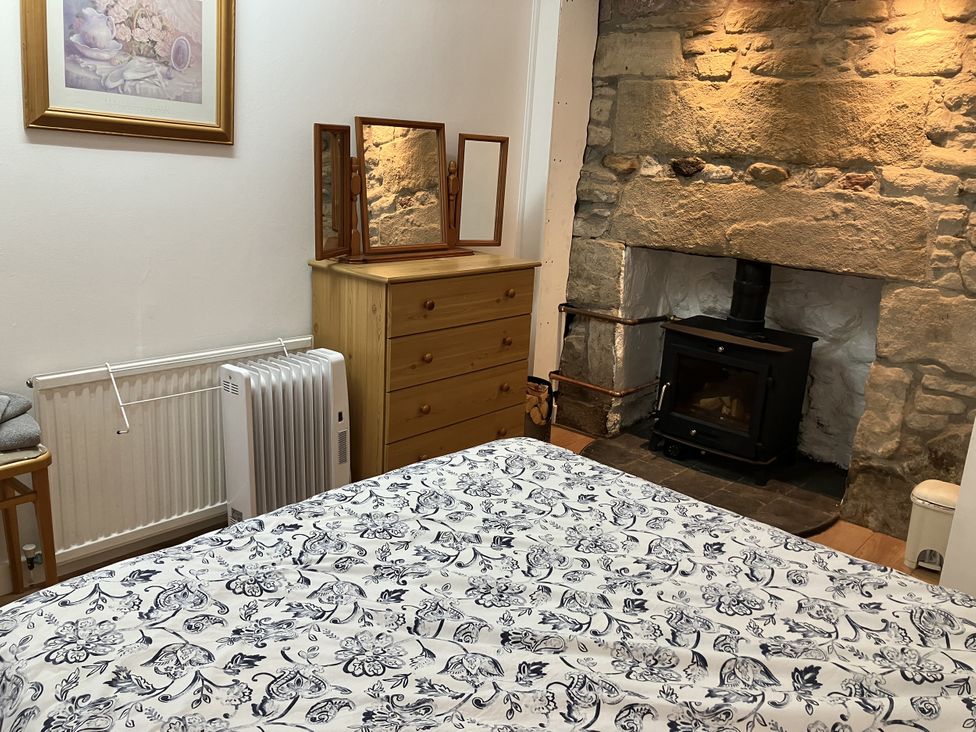 A bedroom with a dresser and mirrors at 3 Dunrobin Street Tain