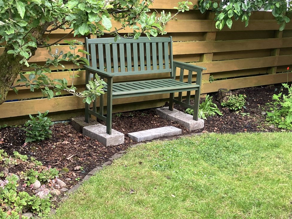 A bench next to plants in a garden at 3 Dunrobin Street, Tain