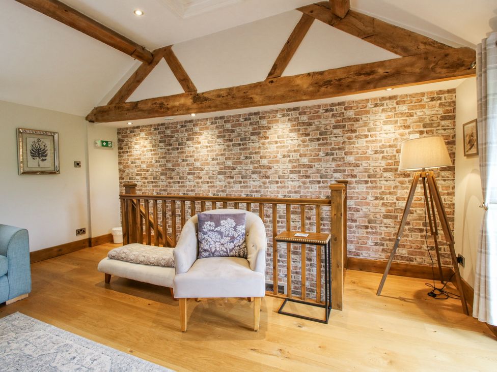 A living room with a sofa and armchair at Meadow Barn Aston On Clun