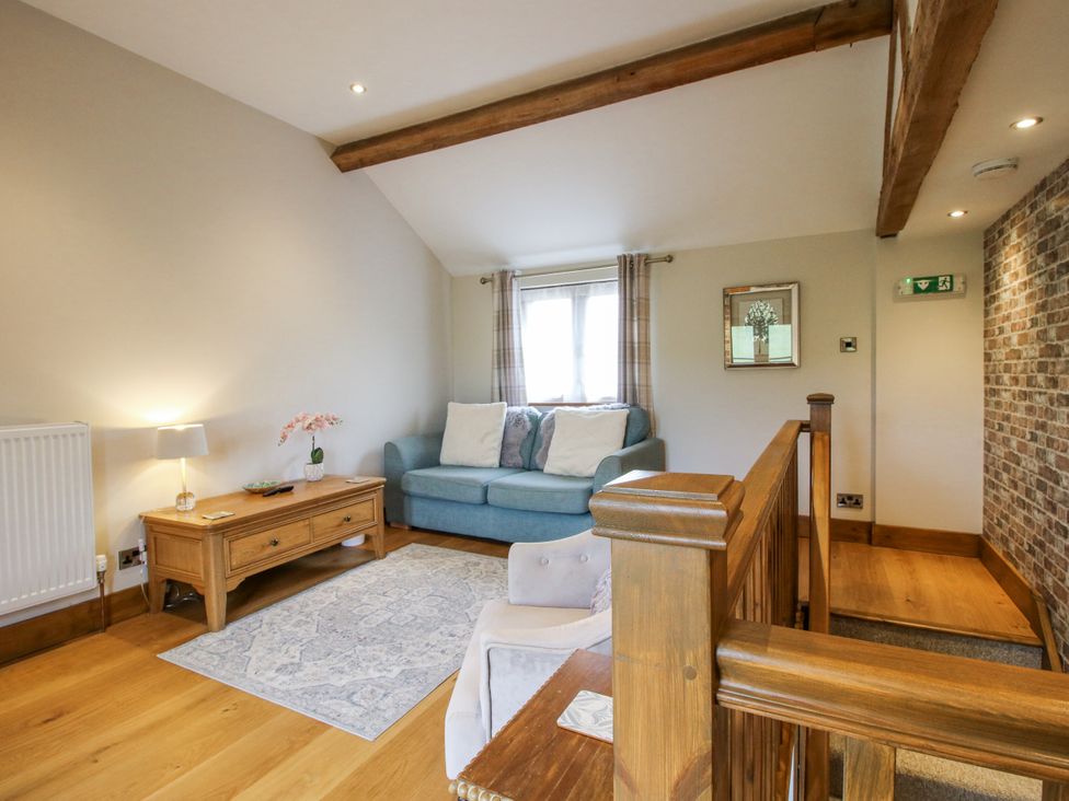 A living room with a sofa and coffee table at Meadow Barn Aston On Clun
