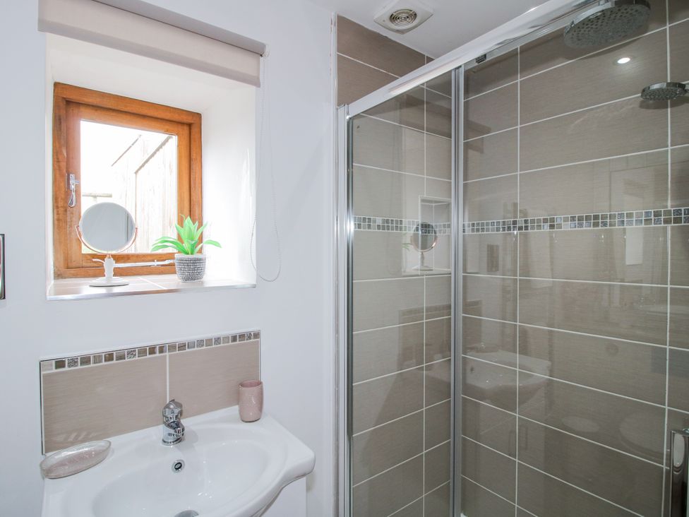 A bathroom with a shower and sink at Meadow Barn Aston On Clun