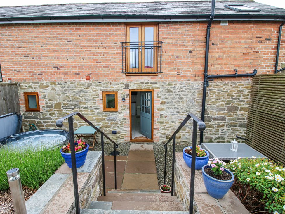 An outdoor area with steps leading to a door at Meadow Barn Aston On Clun