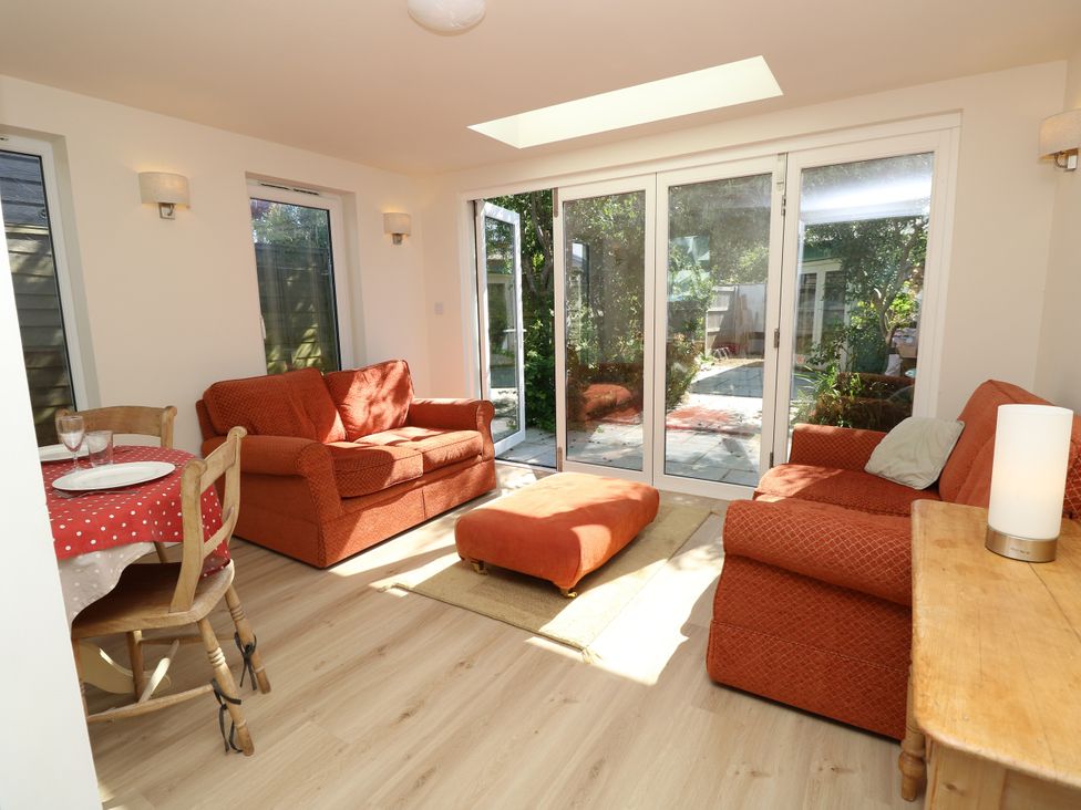 A snug with seating and dining table at Merrilees Yarmouth
