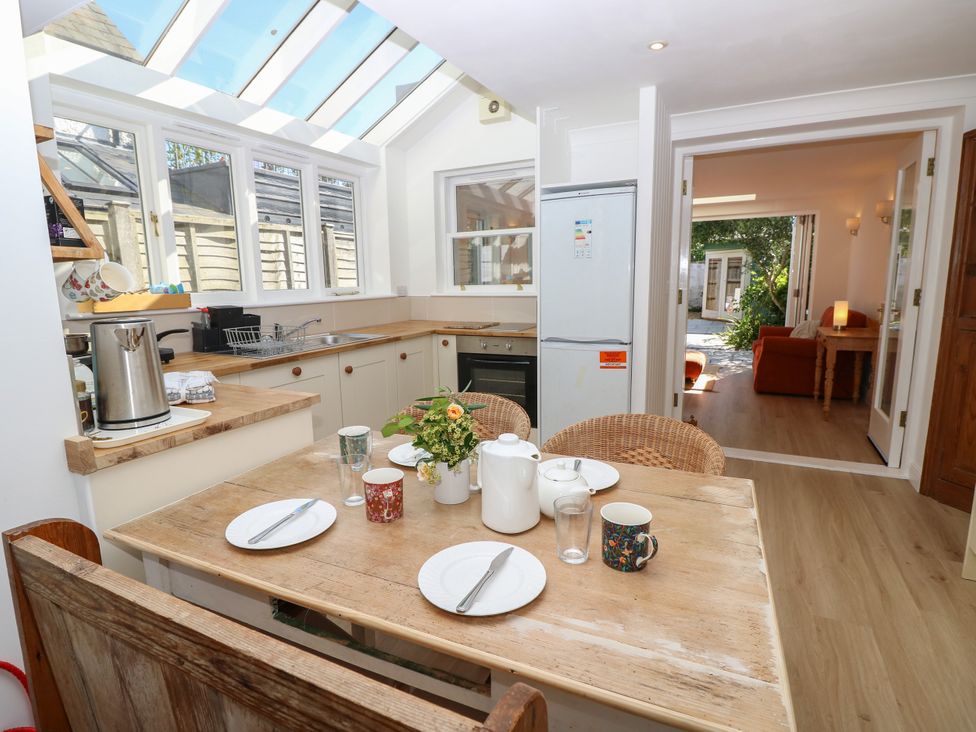 A kitchen with a dining table and chairs at Merrilees Yarmouth