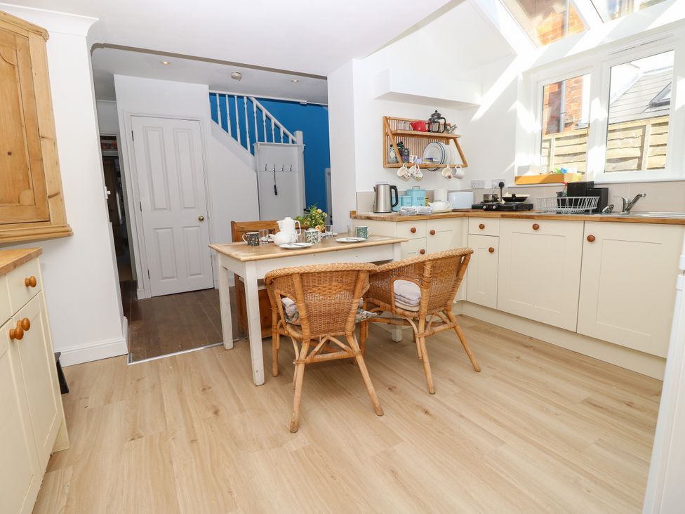 A kitchen with a table and chairs at Merrilees in Yarmouth