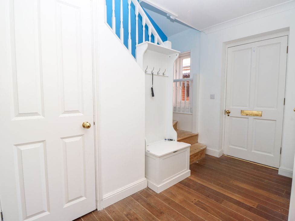 An entryway with a staircase and coatrack at Merrilees in Yarmouth