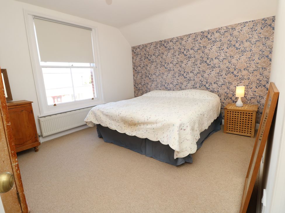 A bedroom with a bed and dresser at Merrilees Yarmouth