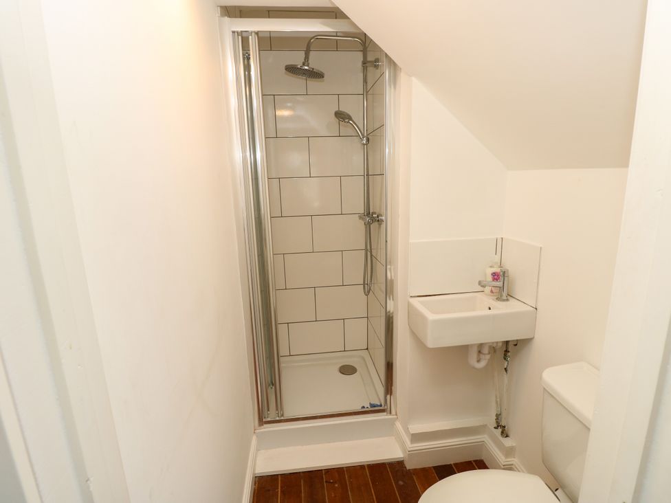 A bathroom with a shower, toilet, and sink at Merrilees in Yarmouth
