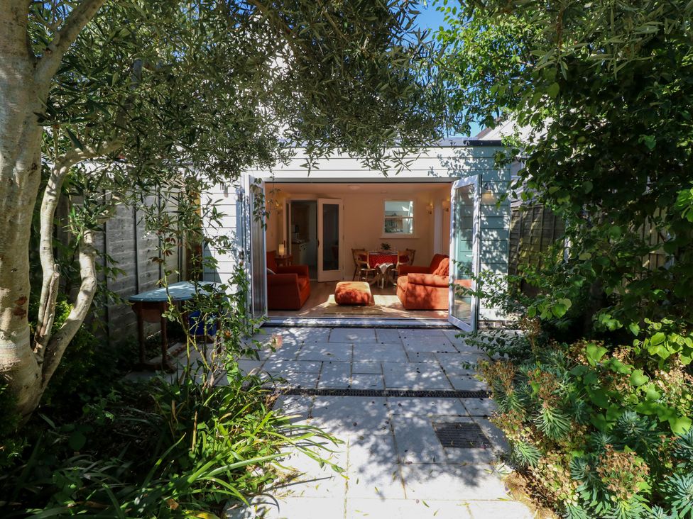 A garden with a view of an indoor sitting area at Merrilees in Yarmouth