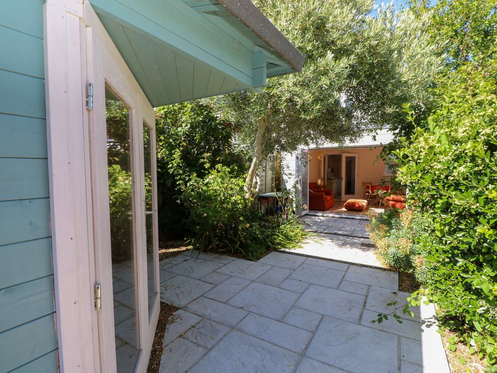 A garden with a view of a room and plant life at Merrilees in Yarmouth