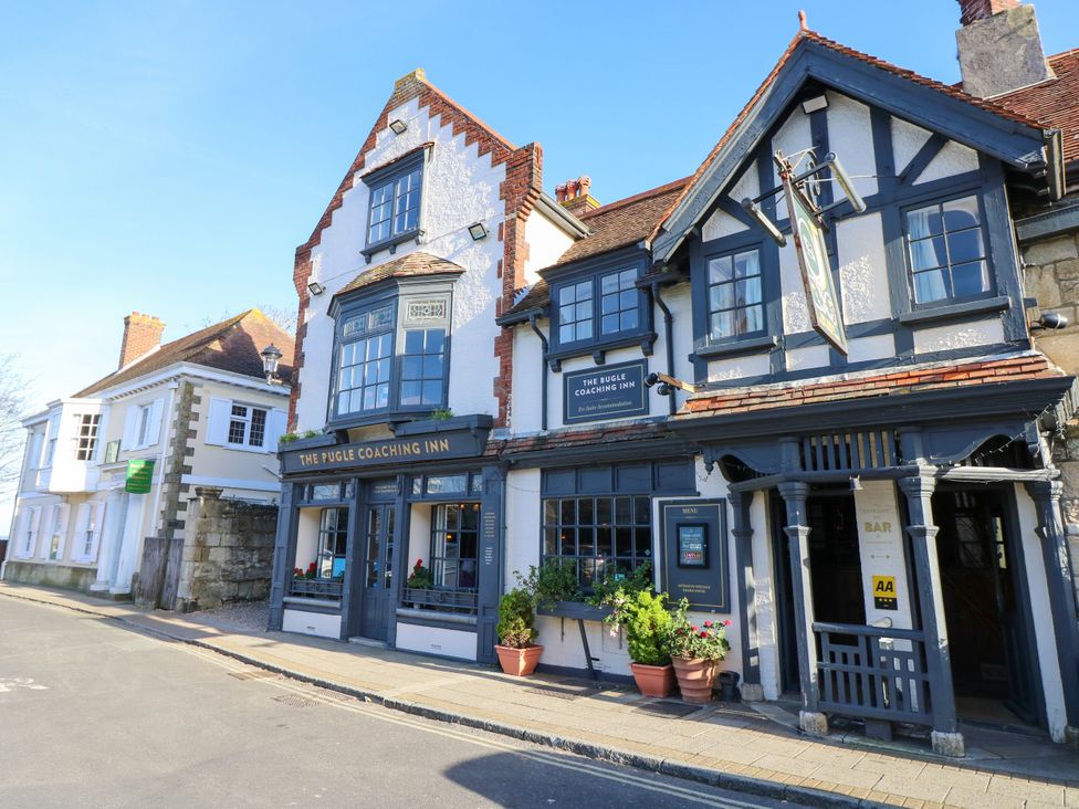 A pub exterior with a sign at The Pugle Coaching Inn in Yarmouth