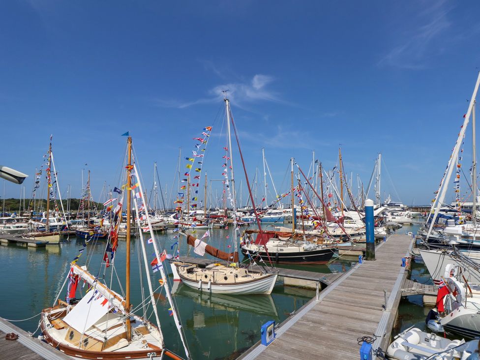 Boats in a harbor with flags on masts at Merrilees Yarmouth