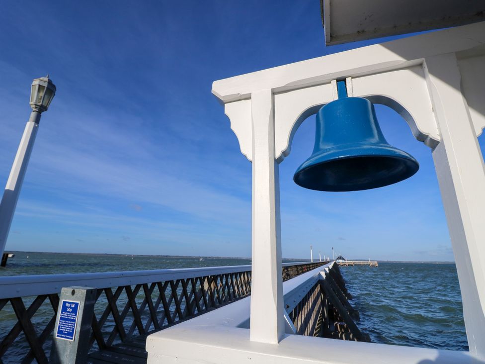 A bell on a pier with a view of water at Merrilees in Yarmouth