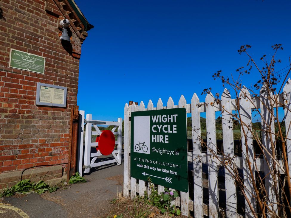 A cycle hire sign and warning sign at the entrance of Southern Railway in Yarmouth