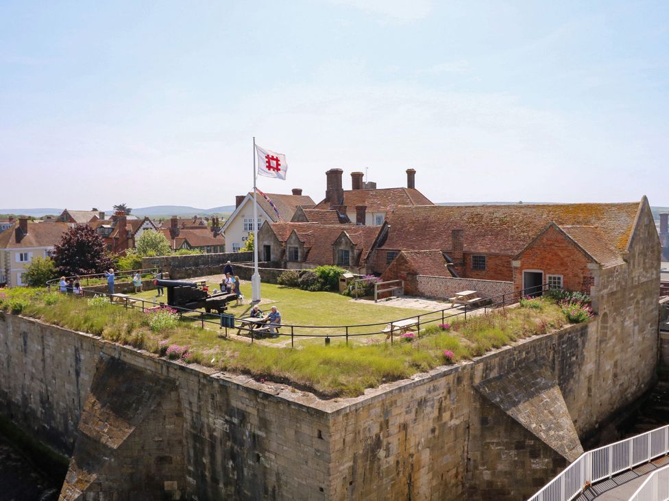 An outdoor area with a castle, grass, and people at Merrilees in Yarmouth