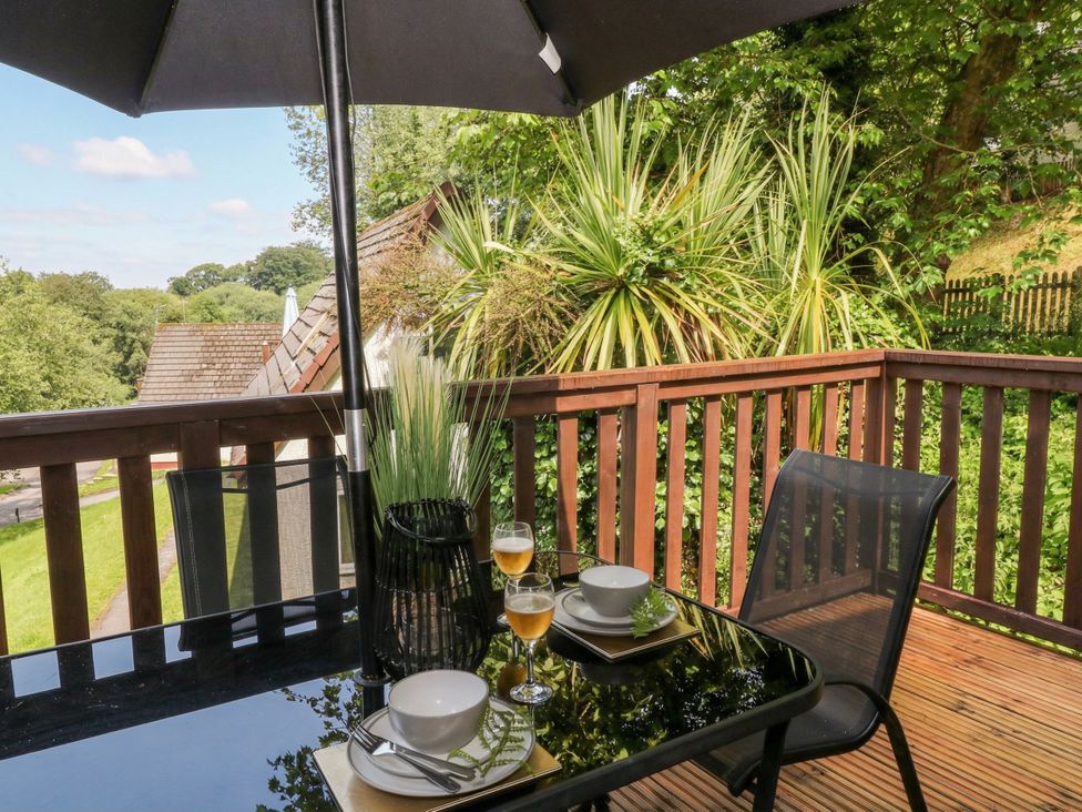 An outdoor dining area with a table and chairs at Lavender Lodge in St. Ann's Chapel, Cornwall