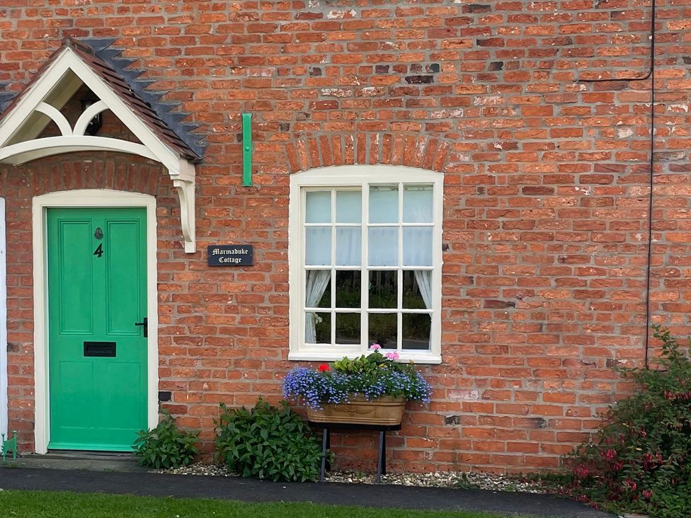 An entrance with a green door and a window at Marmaduke Cottage Market Weighton