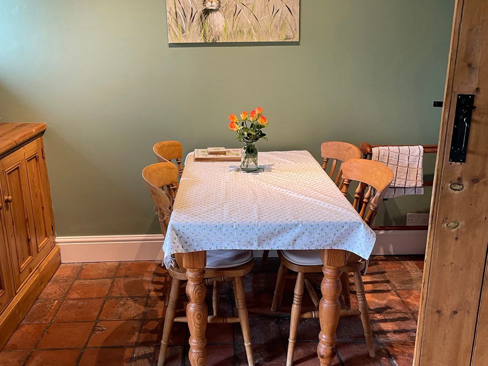 A dining room with a table and chairs at Marmaduke Cottage, Market Weighton