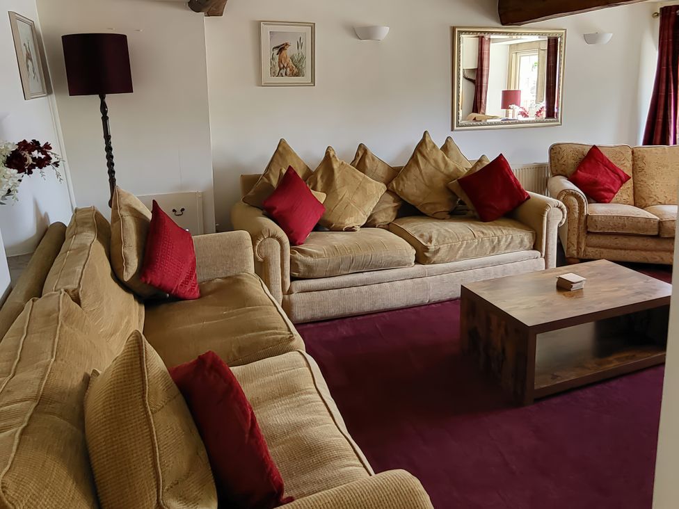 A living room with sofas and a coffee table at The Farmhouse in Youlgreave