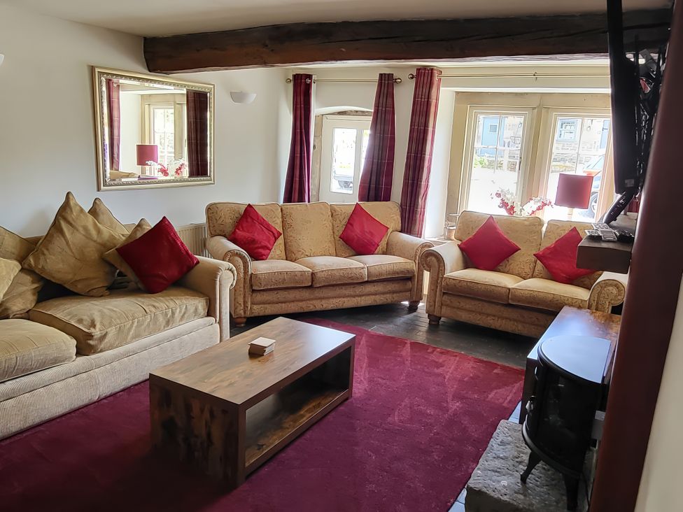 A living room with sofas and a coffee table at The Farmhouse in Youlgreave