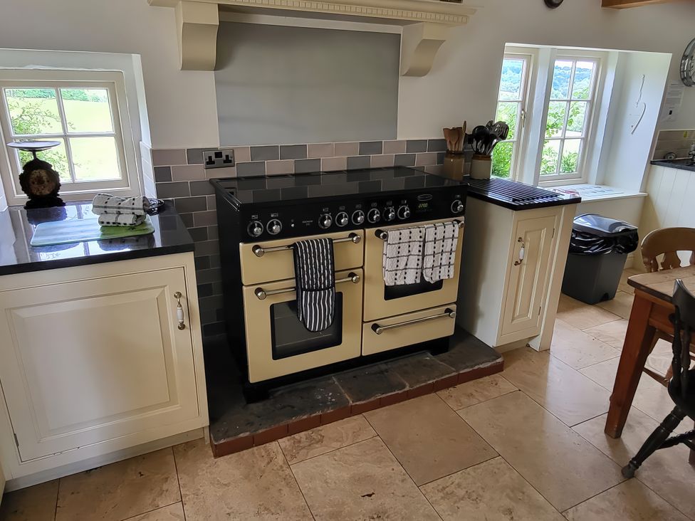 A kitchen with an oven and cabinets at The Farmhouse in Youlgreave