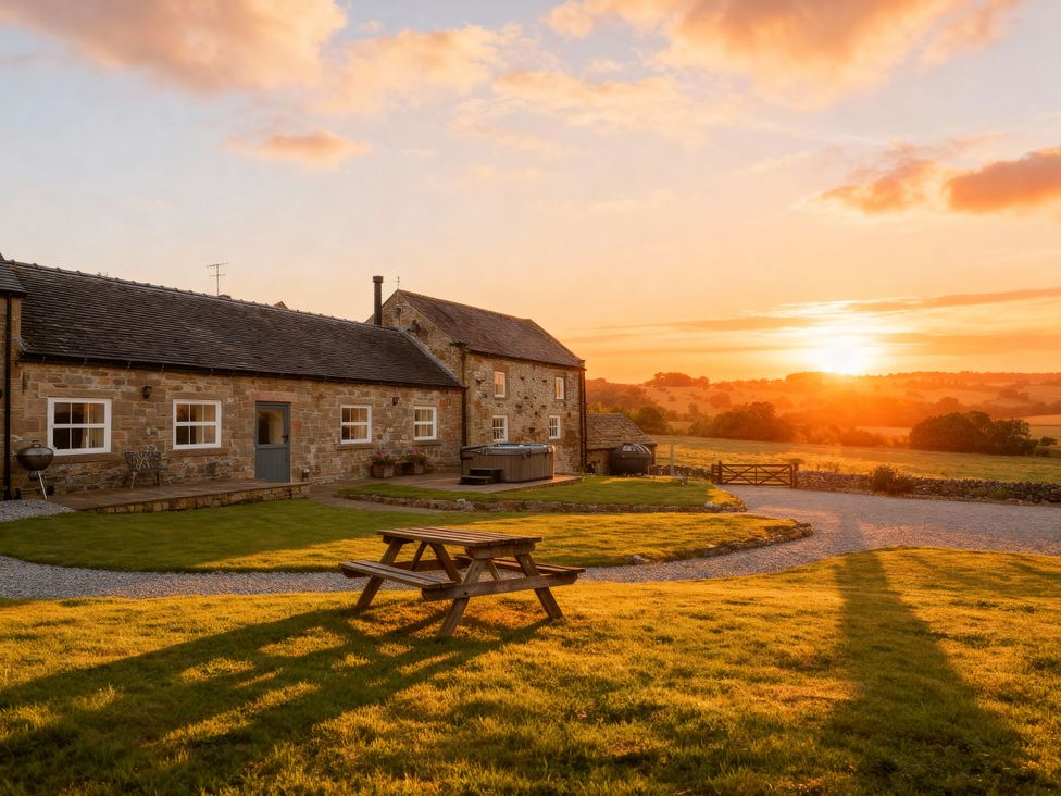 An outdoor area with a picnic table and house at The Dairy Middleton near Youlgreave