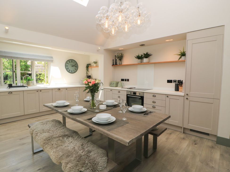 A kitchen with a dining table and chairs at 12 Manor Farm Close Kingham