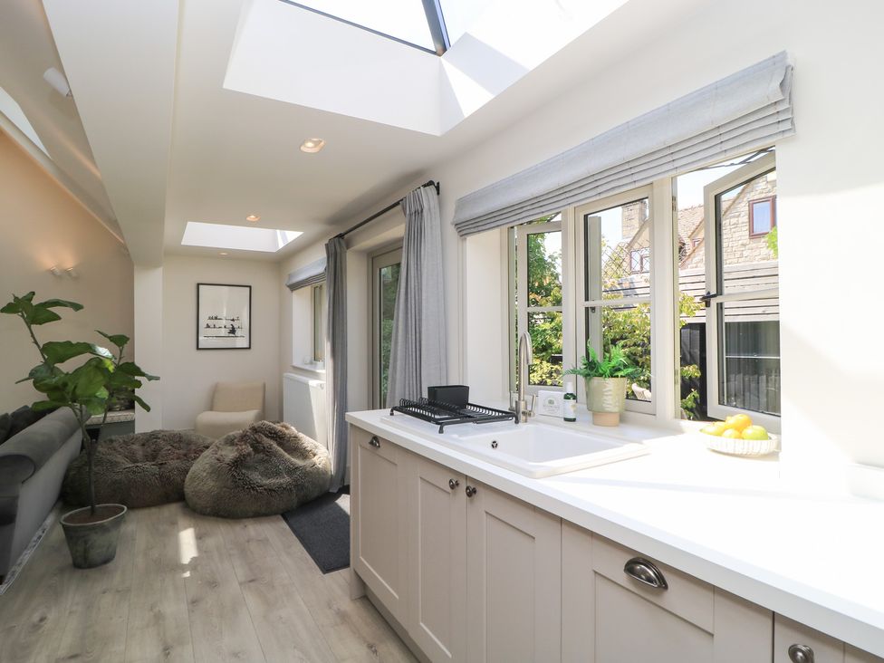 A kitchen with a sink and windows at 12 Manor Farm Close Kingham