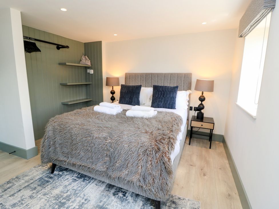 A bedroom with a bed and bedside table at 12 Manor Farm Close Kingham