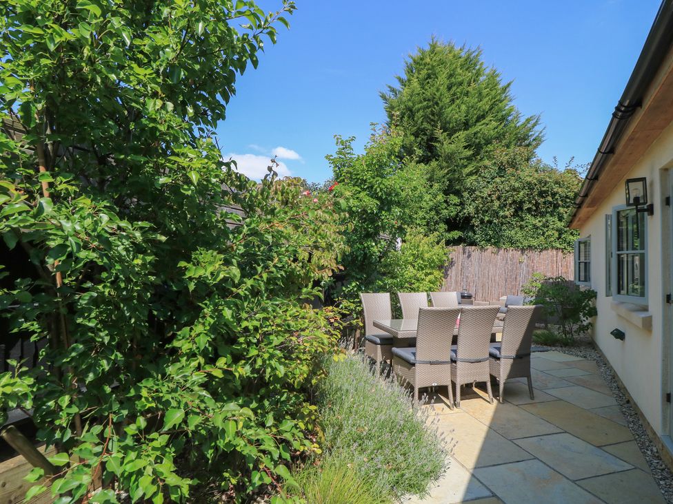 A patio area with table and chairs at 12 Manor Farm Close Kingham