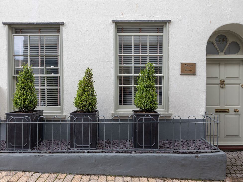 An outdoor area with windows and planters at George House in Dartmouth