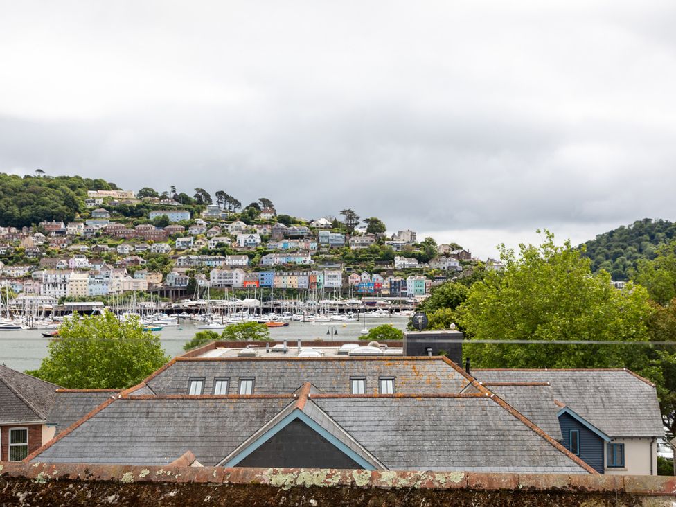 A view of houses and boats by the water at George House in Dartmouth
