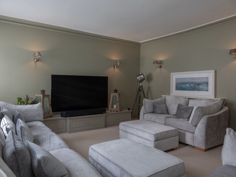 A living room with a sofa and television at George House in Dartmouth