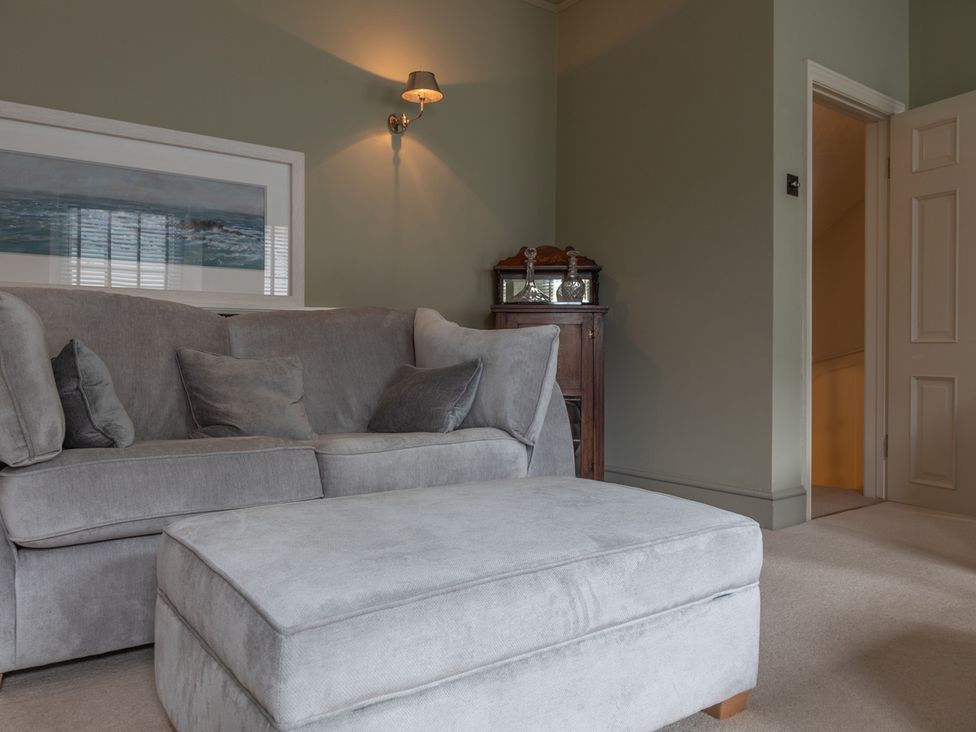 A living room with a sofa and ottoman at George House Dartmouth