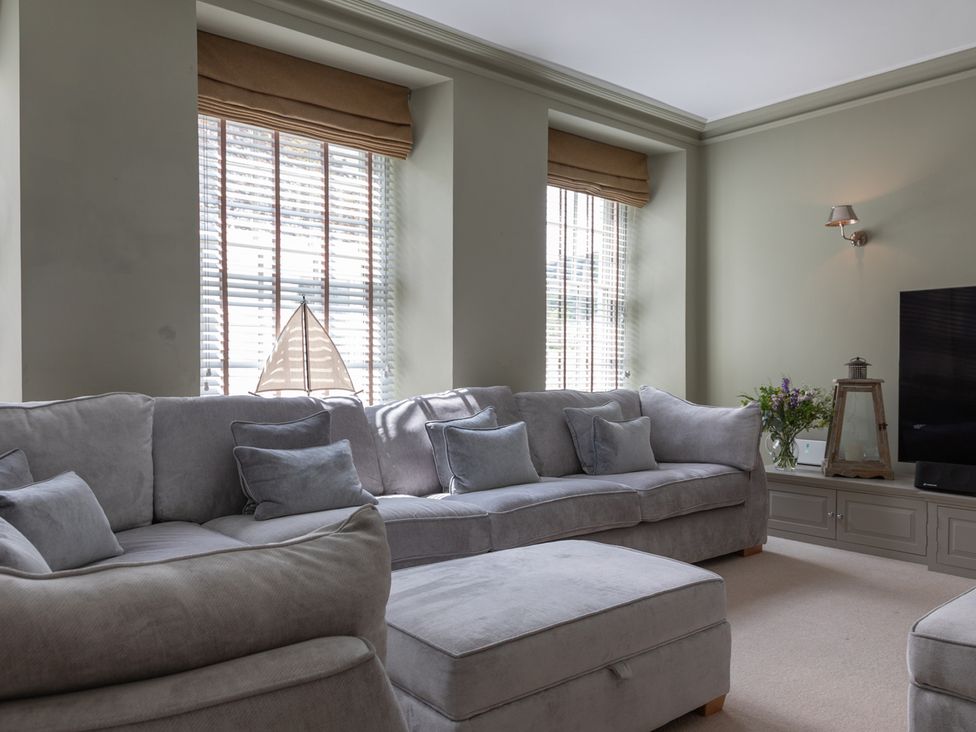 A living room with a sofa and television at George House in Dartmouth